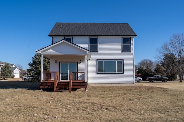 back of house with a yard and covered porch