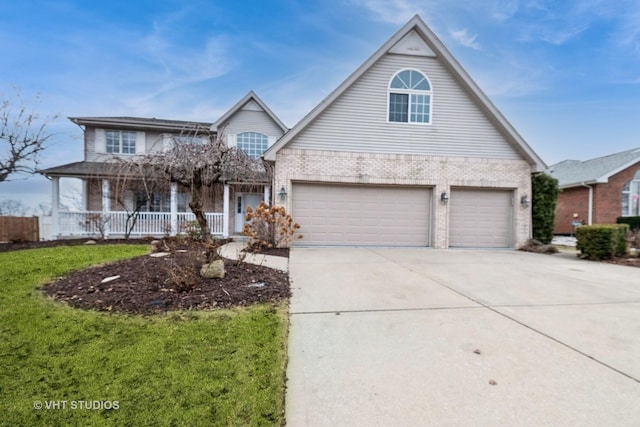 view of front facade featuring a garage, a front yard, and covered porch