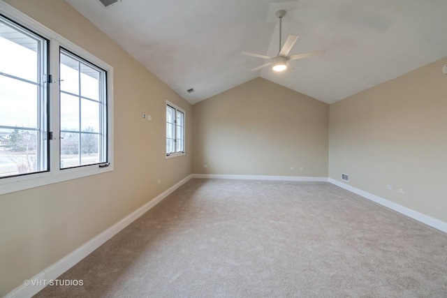 unfurnished room with vaulted ceiling, ceiling fan, and carpet