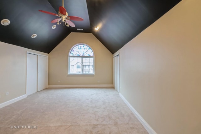 bonus room featuring ceiling fan, light colored carpet, and lofted ceiling