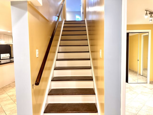 staircase with tile patterned floors