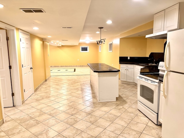 kitchen with light tile patterned flooring, pendant lighting, white cabinetry, sink, and white appliances