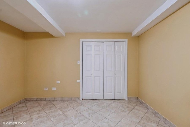 unfurnished bedroom with a closet and light tile patterned floors