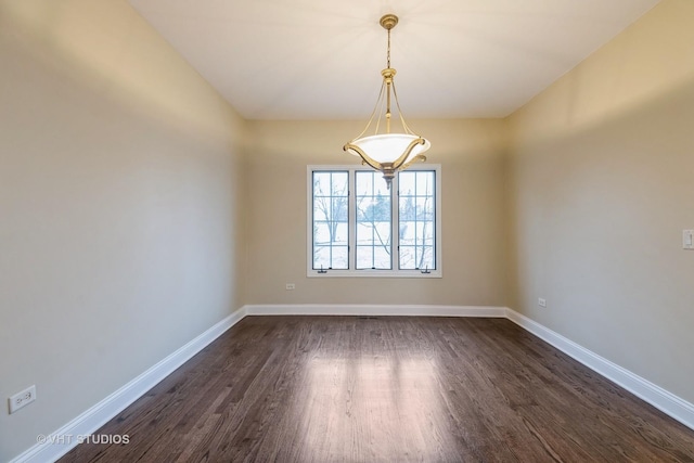 spare room with dark hardwood / wood-style floors