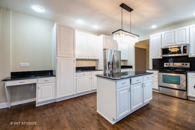 kitchen with white cabinetry, appliances with stainless steel finishes, a center island, and pendant lighting