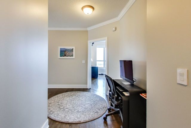 office area with wood-type flooring and ornamental molding