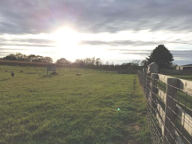 view of yard featuring fence and a rural view