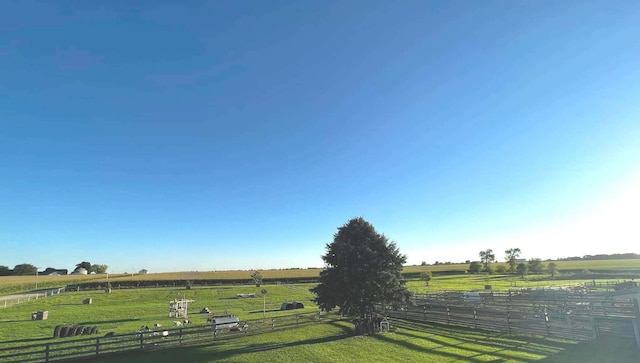 view of yard featuring fence and a rural view