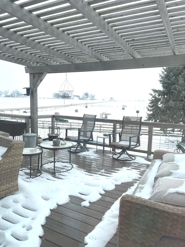 snow covered deck with a pergola