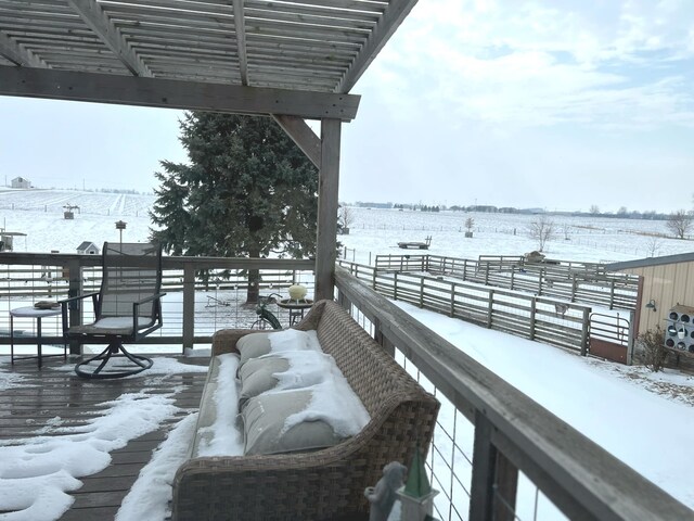 view of snow covered back of property