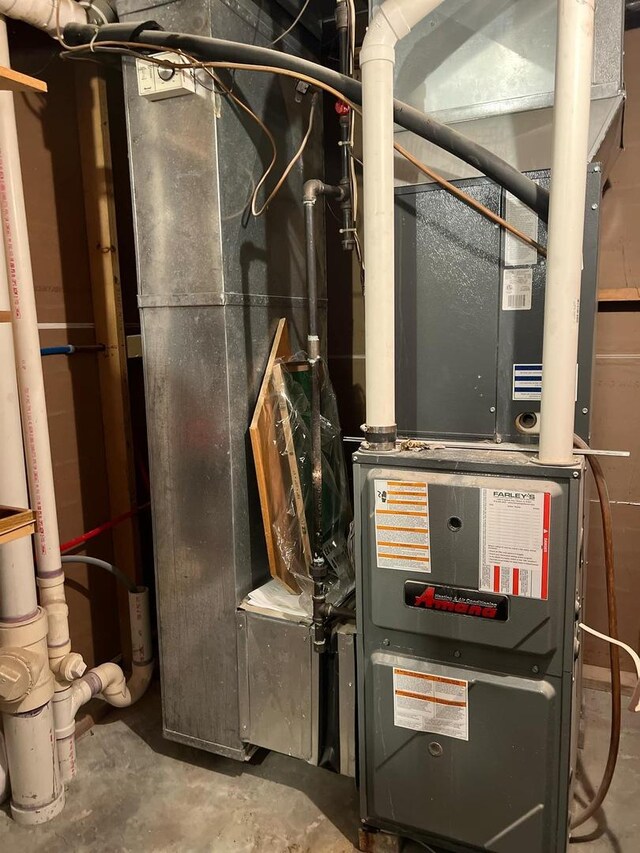 utility room featuring heating unit