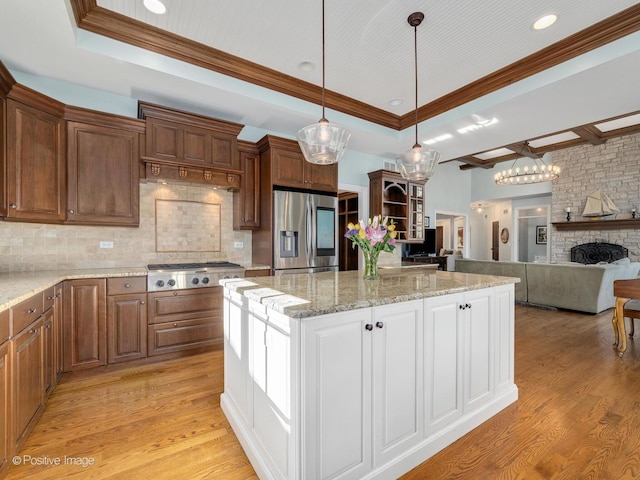 kitchen with tasteful backsplash, light wood-type flooring, and appliances with stainless steel finishes