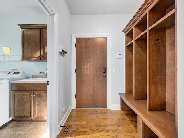 mudroom featuring sink and light hardwood / wood-style flooring