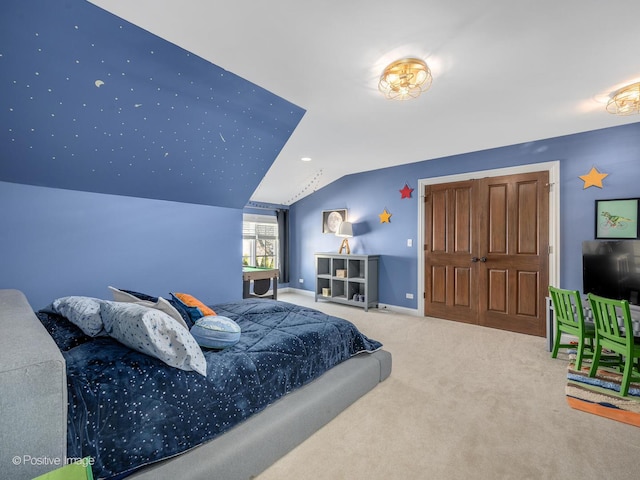 bedroom featuring lofted ceiling and carpet floors