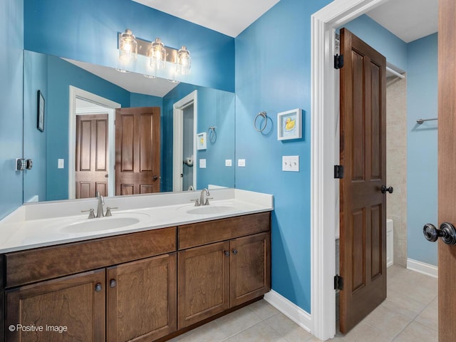 bathroom featuring tile patterned floors, vanity, and a washtub