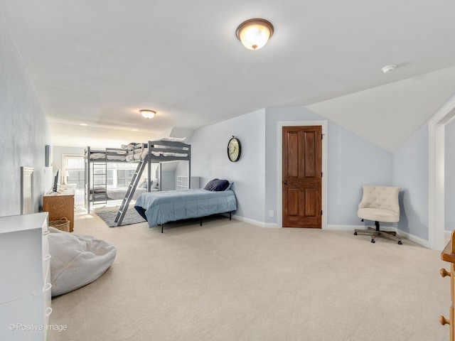 carpeted bedroom featuring lofted ceiling