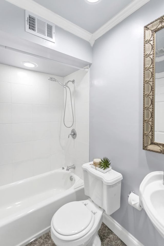 full bathroom with sink, crown molding, tiled shower / bath combo, and toilet