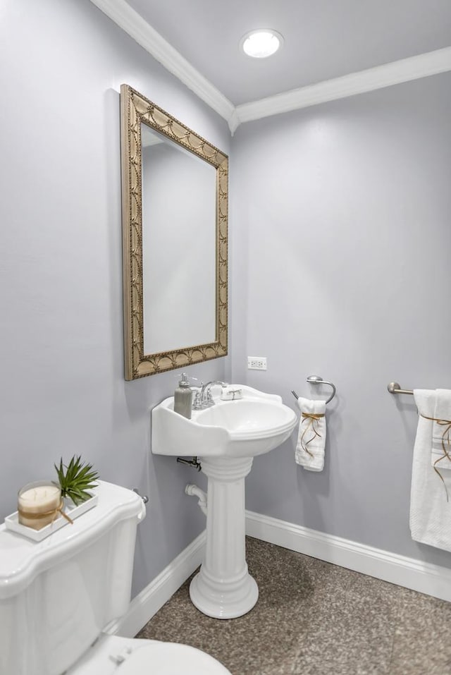 bathroom with crown molding and toilet