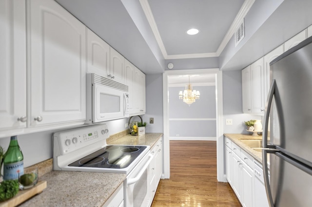 kitchen with white appliances and white cabinets