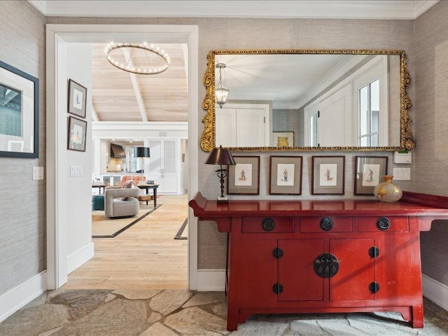 corridor featuring vaulted ceiling, ornamental molding, wood finished floors, and baseboards