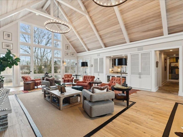 living room with a healthy amount of sunlight, light wood-style flooring, and an inviting chandelier