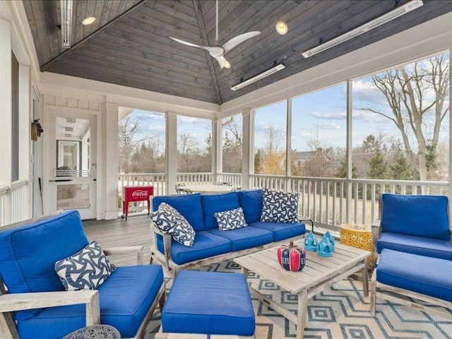 sunroom / solarium with vaulted ceiling, plenty of natural light, and ceiling fan