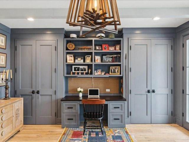 office area with light wood-style floors, recessed lighting, beamed ceiling, and built in study area