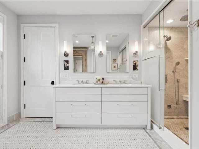 full bath featuring a sink, a shower stall, and double vanity