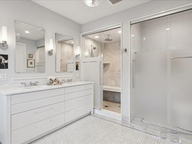 bathroom with a stall shower, a sink, and double vanity