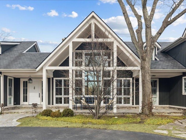 view of front of property featuring a porch and roof with shingles