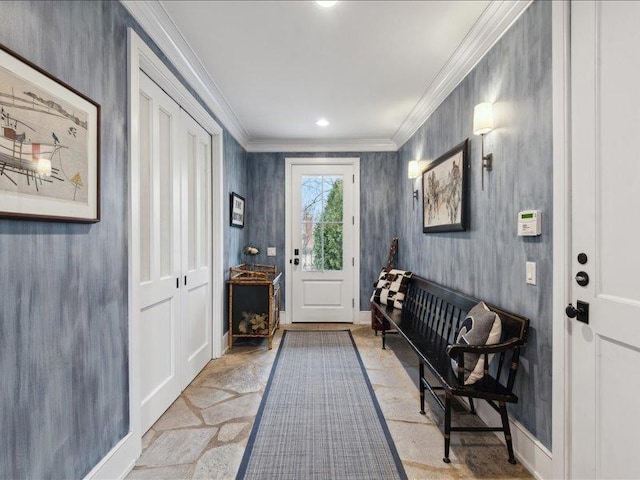 doorway featuring ornamental molding, stone tile flooring, and baseboards