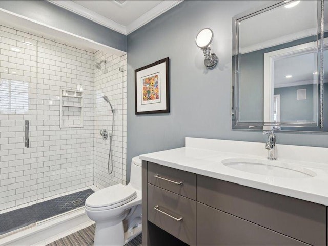 bathroom featuring toilet, a shower stall, crown molding, and vanity