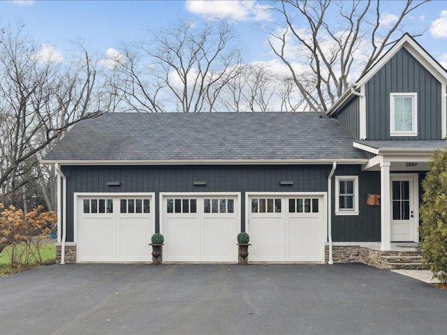 garage featuring aphalt driveway