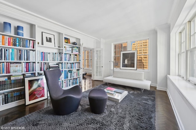 living area featuring crown molding and dark parquet floors