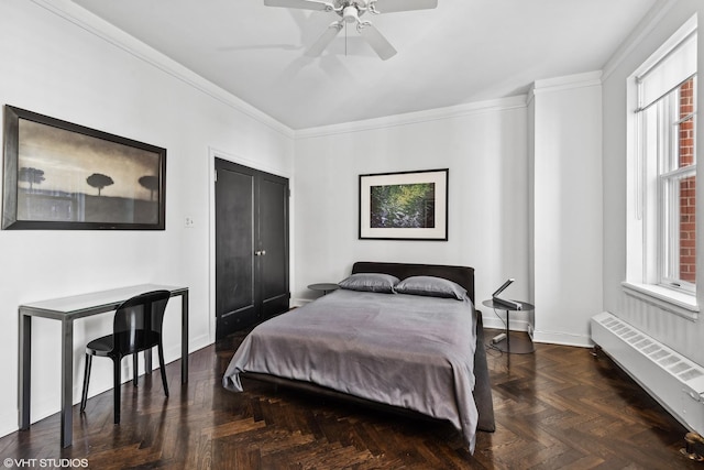 bedroom featuring crown molding, ceiling fan, radiator, and dark parquet floors