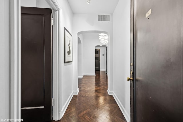 hallway with dark parquet flooring