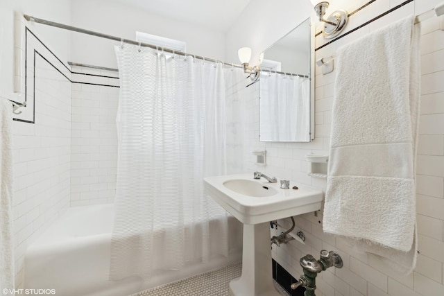 bathroom with tile patterned floors and shower / bath combo with shower curtain