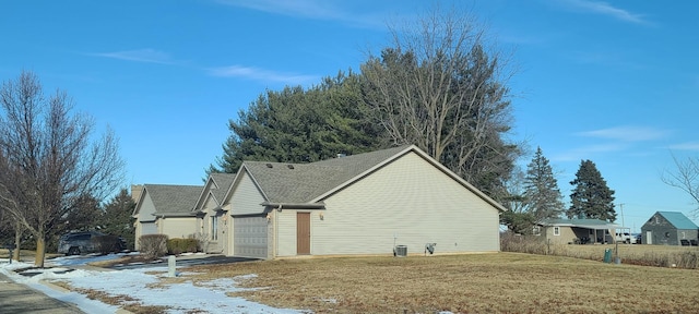 view of home's exterior featuring a garage and a lawn