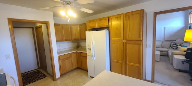 kitchen with white fridge with ice dispenser and ceiling fan