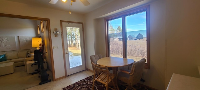 tiled dining area featuring ceiling fan