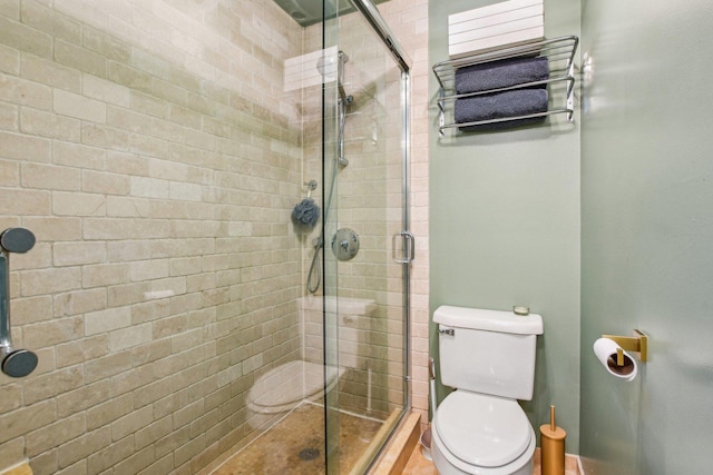 bathroom featuring an enclosed shower and toilet