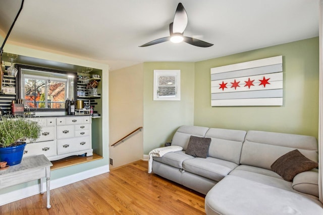 living room featuring light hardwood / wood-style flooring and ceiling fan