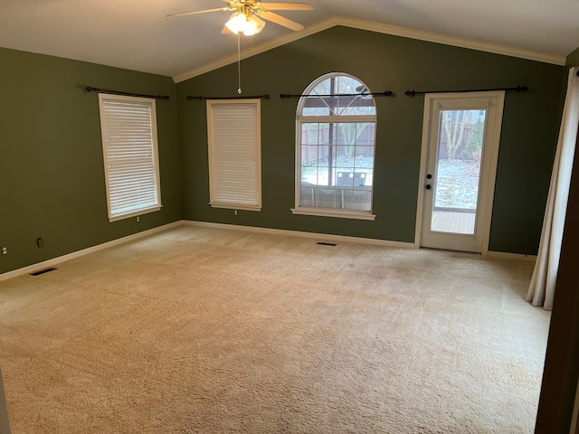 empty room featuring ceiling fan, lofted ceiling, and light carpet