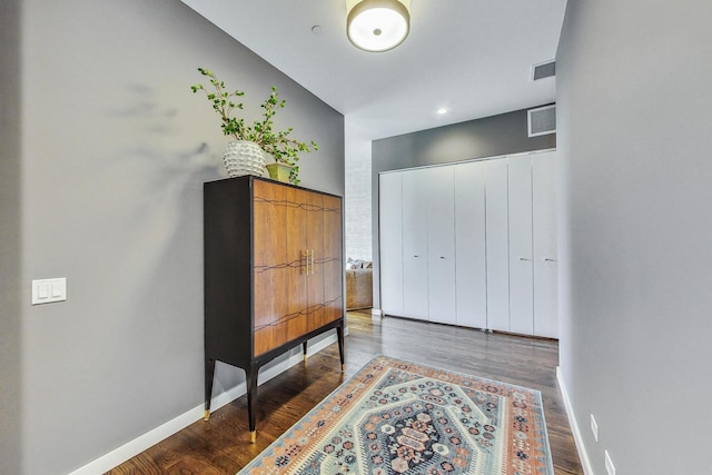 corridor with hardwood / wood-style floors