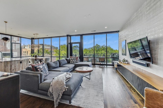 living room with floor to ceiling windows, plenty of natural light, and dark wood-type flooring