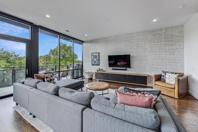 living room featuring a wall of windows and hardwood / wood-style floors