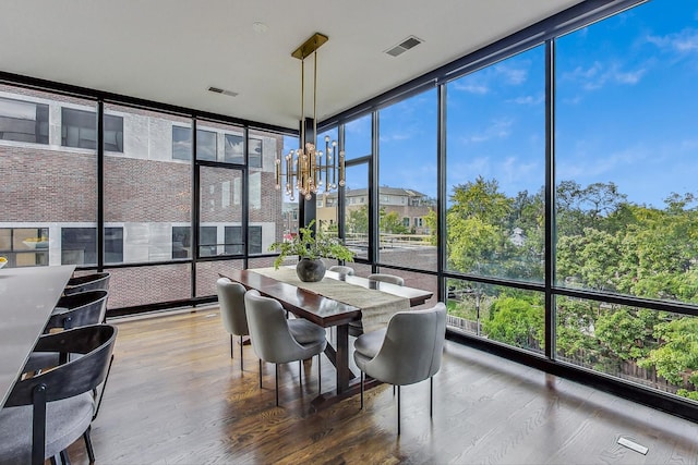 sunroom featuring a notable chandelier and a healthy amount of sunlight