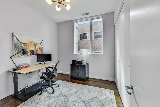 office featuring dark wood-type flooring and a notable chandelier