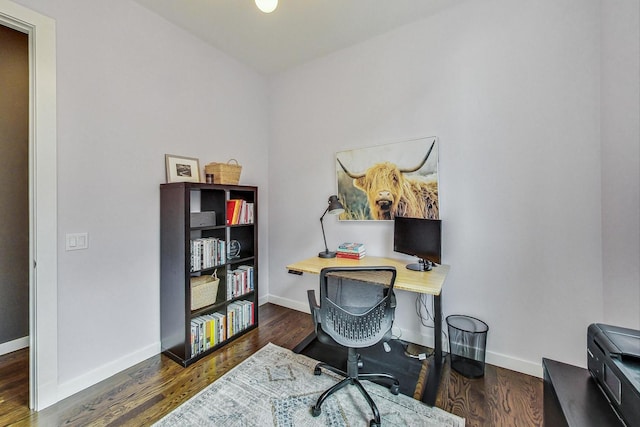 home office with dark hardwood / wood-style flooring