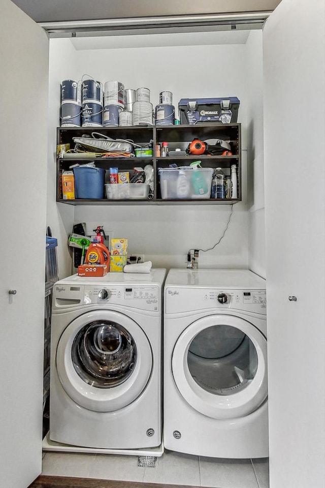 washroom featuring tile patterned flooring and washer and dryer